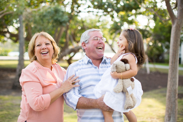 Grandparents laughing with granddaughter Miami Beach