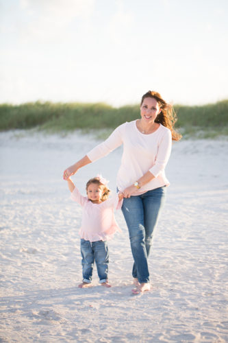 Mother holding daughter's hand Miami Beach