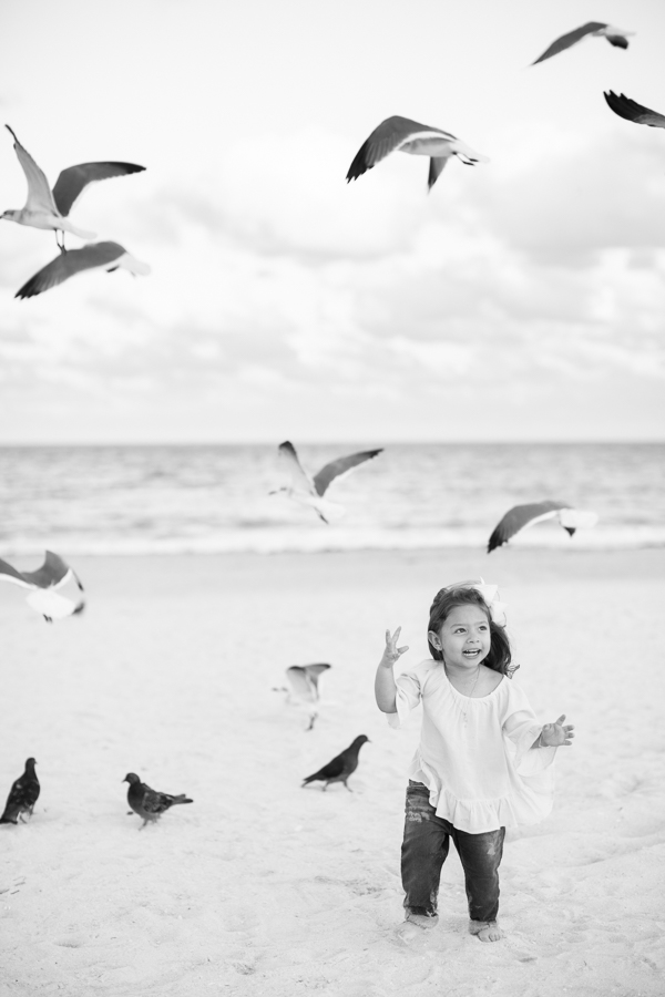 Girl running after the birds Miami Beach
