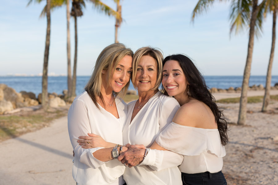 Mother and daughters hug at Matheson Hammock.