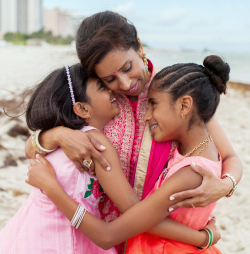 mother hugs her daughters