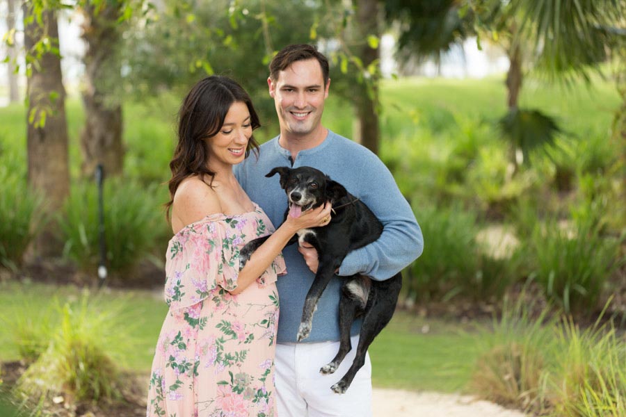 family portrait with their dog expecting first child
