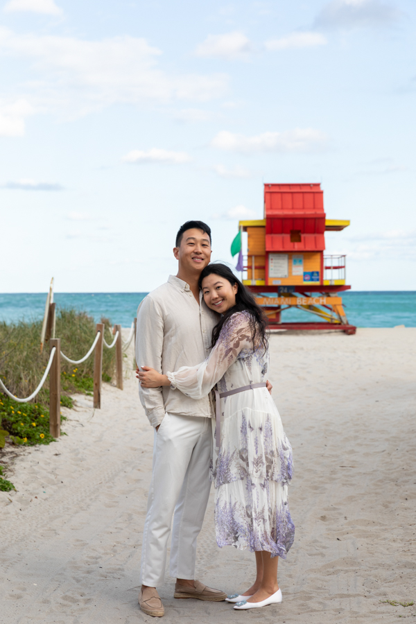 couple in front of lifeguard house miami