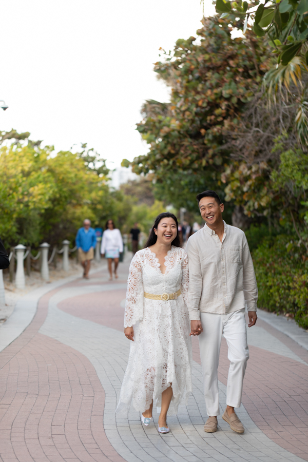 couple walking on miami beach boardwalk