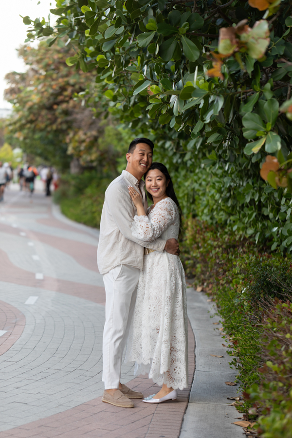 couple smiling on boardwalk