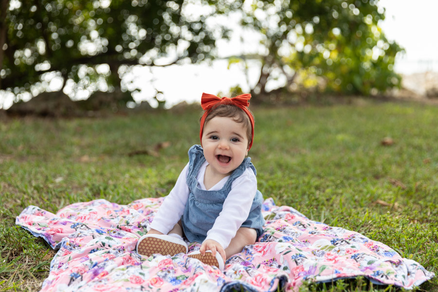 baby smiling on blanket