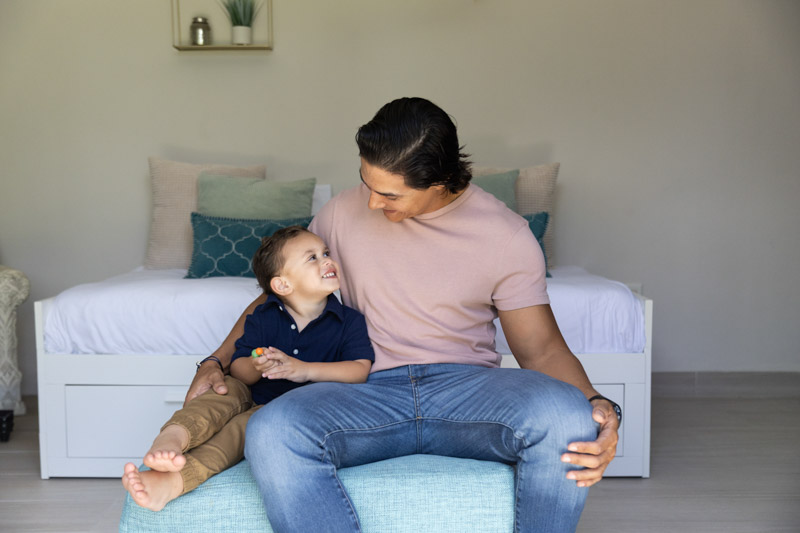 father looking at toddler son