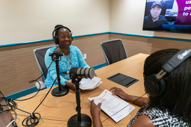 Senior Planet Miami member recording a podcast episode in the center's studio